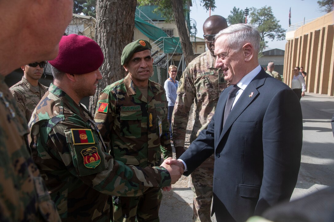 Defense Secretary James N. Mattis shakes hands with Afghan service members.