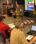 U.S. Army Maj. Gen. Bill Hall, commander, Joint Task Force Civil Support, gives opening remarks during a class about online collaboration program for members of Joint Task Force Civil Support Sept. 5 at Mullan Hall. Hall explains how effective communication increases readiness, responsiveness and relationships, and contributes to better unity of effort during a crisis response. When providing Defense Support of Civil Authorities, Hall says increased communication will help the task force respond more rapidly in order to save lives and help civilian partners during a time of great need. (DoD photo by Lt. Col. Karen Roganov)