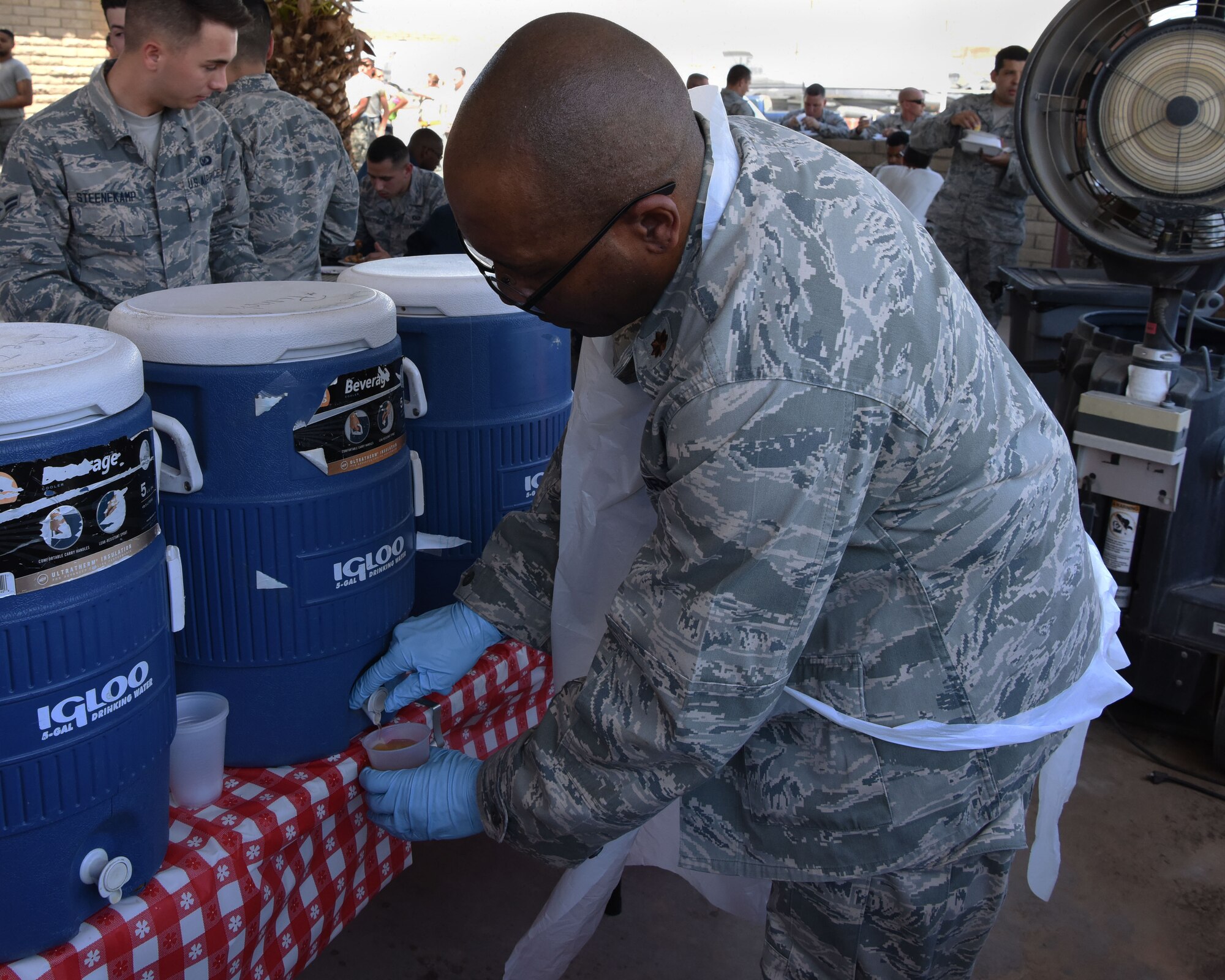 Maj. Andre Mooney, 944th Fighter Wing Individual Mobilization Augmentee chaplain, serves beverages to Airmen during the Flightline Feast Sept. 6, 2018, at Luke Air Force Base, Ariz.