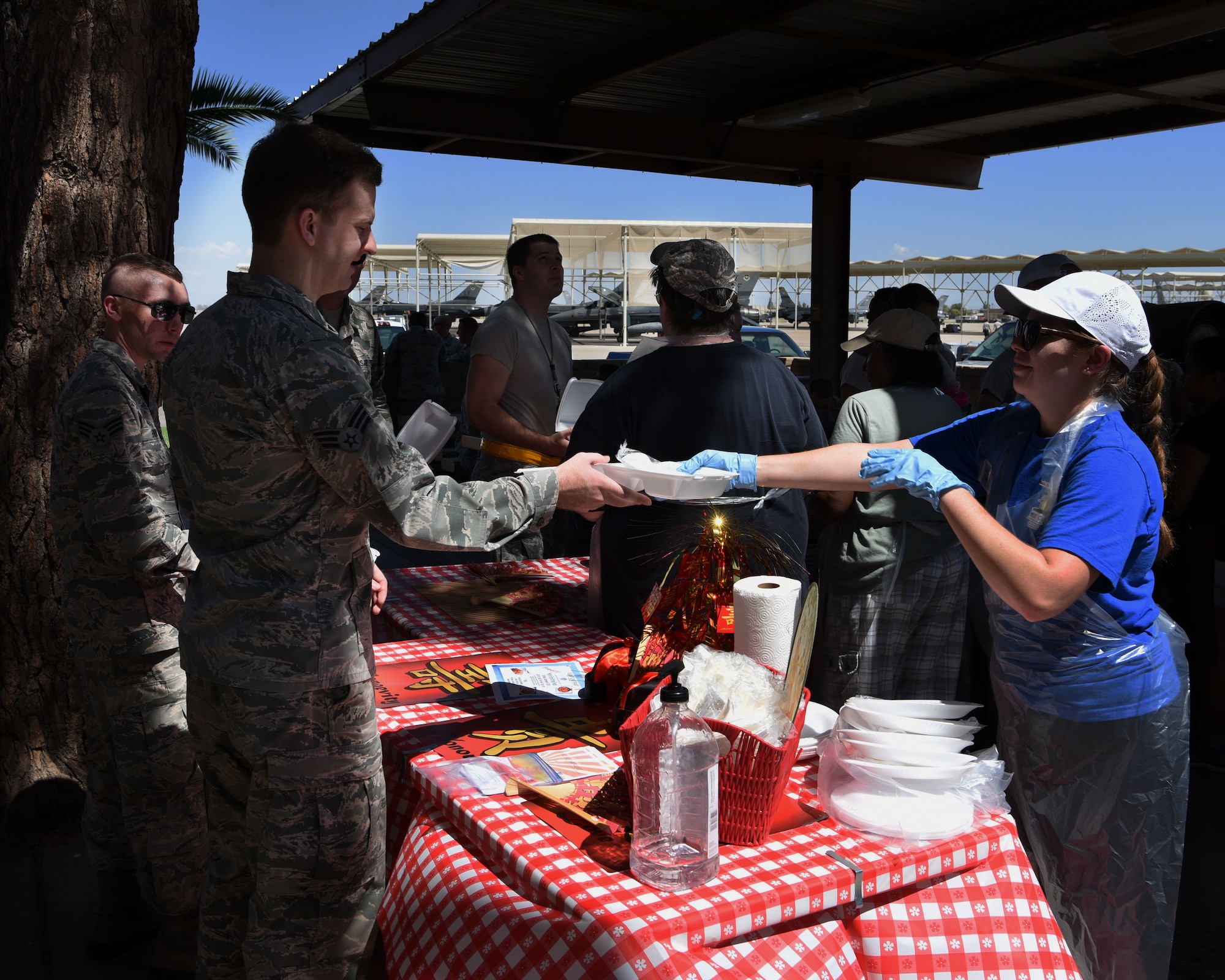 Volunteers from the Catholic and Protestant community serve Airmen during the Flightline Feast Sept. 6, 2018, at Luke Air Force Base, Ariz.