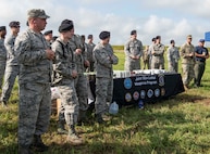 Members from local police department, local sheriff's department, 126th Air Refueling Wing, 375th Security Forces Squadron, and the 375th Logistics Readiness Squadron learn about the M203 40mm grenade launcher during the Non-Lethal Weapons Familiarization event Aug. 30, 2018, at the Illinois National Guard Training Area in Sparta, Illinois.