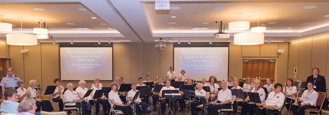 The WAF Band poses for a photo with current members of the USAF Band and Col Arnald D. Gabriel (ret.)