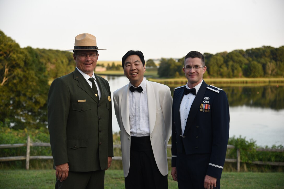 Lt. Philip Emory poses with the conductor of the Cape Symphony Mr. Jung-Jo Park and Cape Cod National Seashore Superintendent Brian Carlstrom
