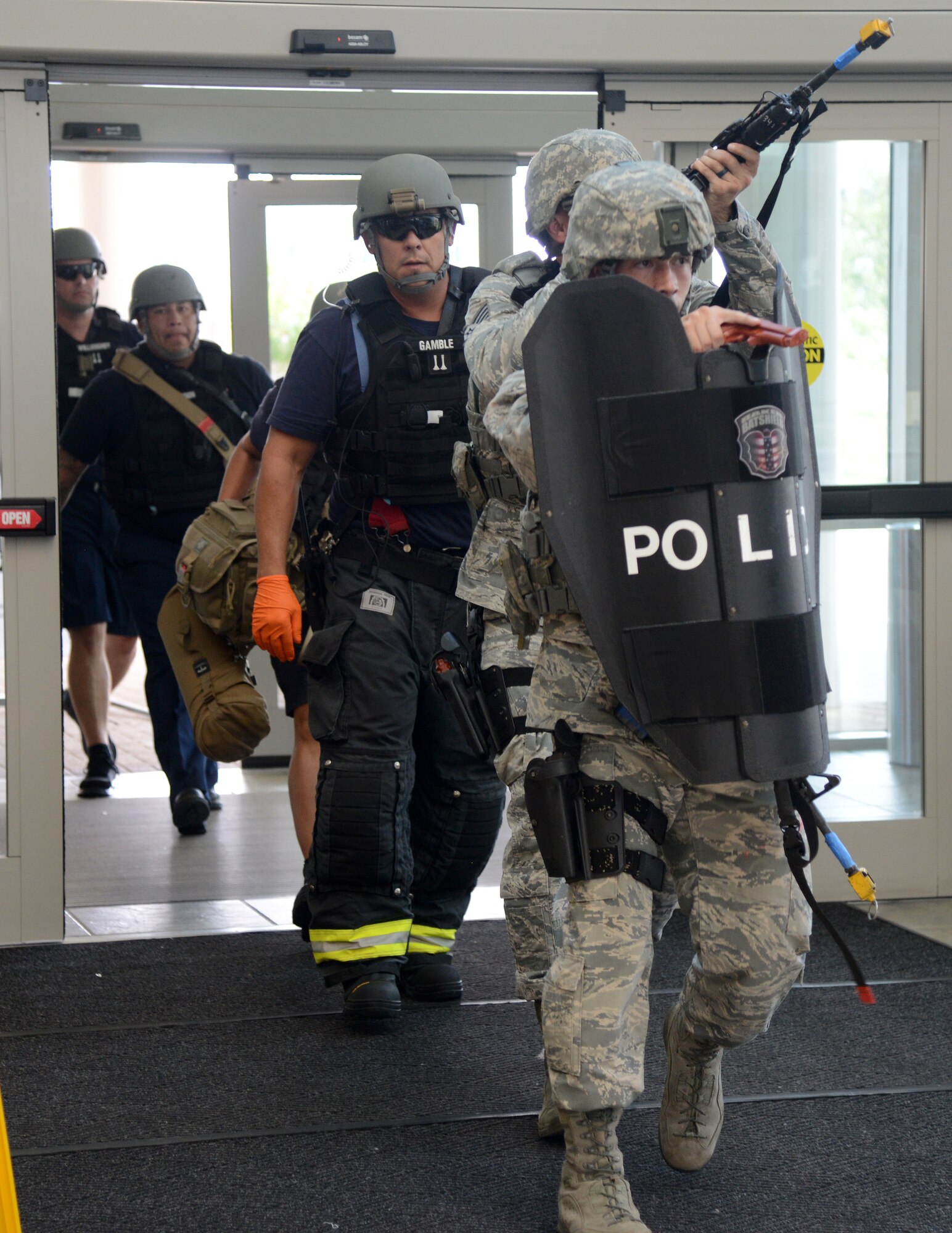 The 72nd Security Forces personnel lead a team of Tinker firefighters in the building to assess and help the wounded victims.