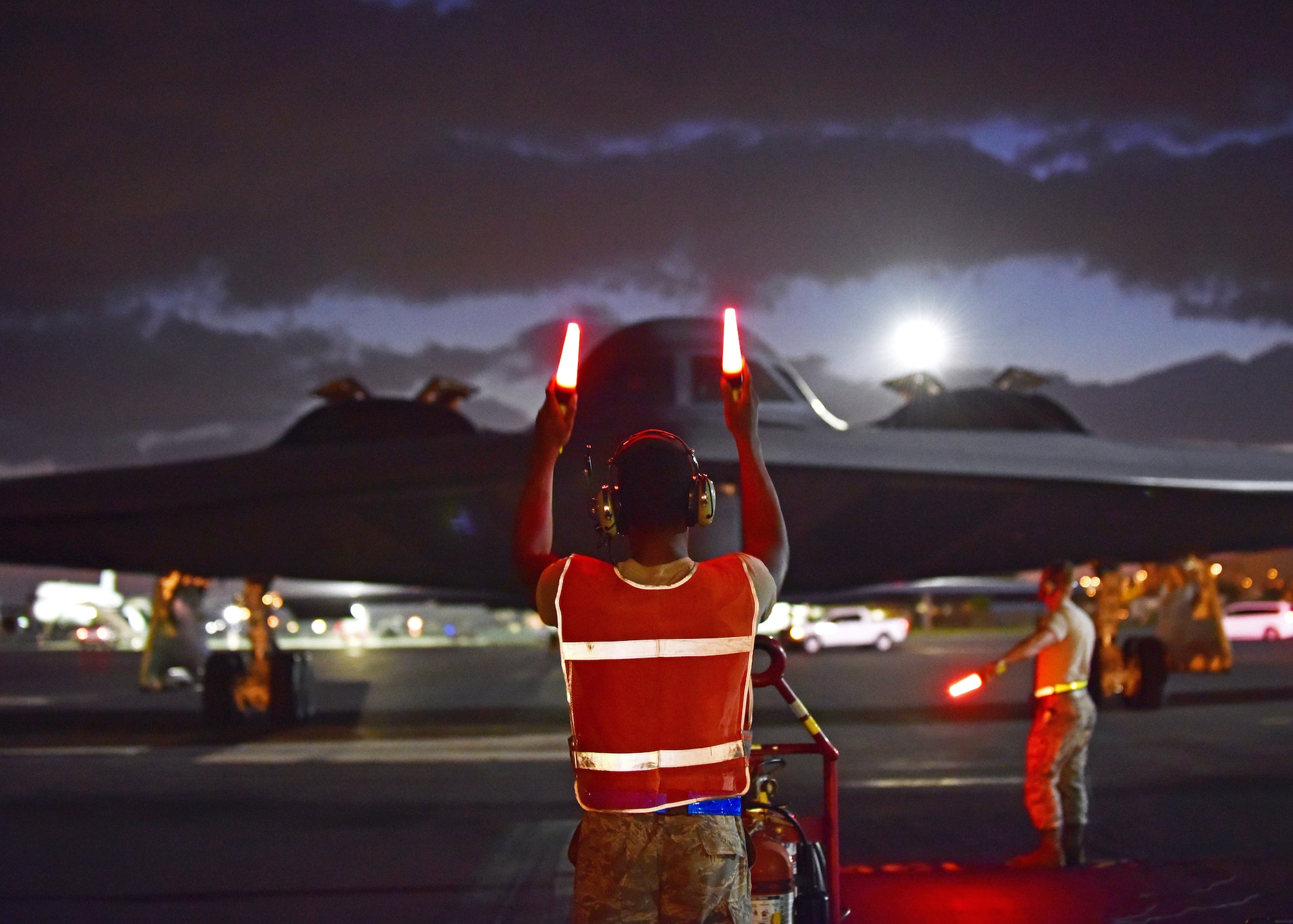 U.S. Air Force Airman 1st Class Christopher Rucker, a crew chief assigned to the 509th Aircraft Maintenance Squadron, marshals a B-2 Spirit returning from a routine training mission at Joint Base Pearl Harbor-Hickam, Hawaii, Sept. 6, 2018.