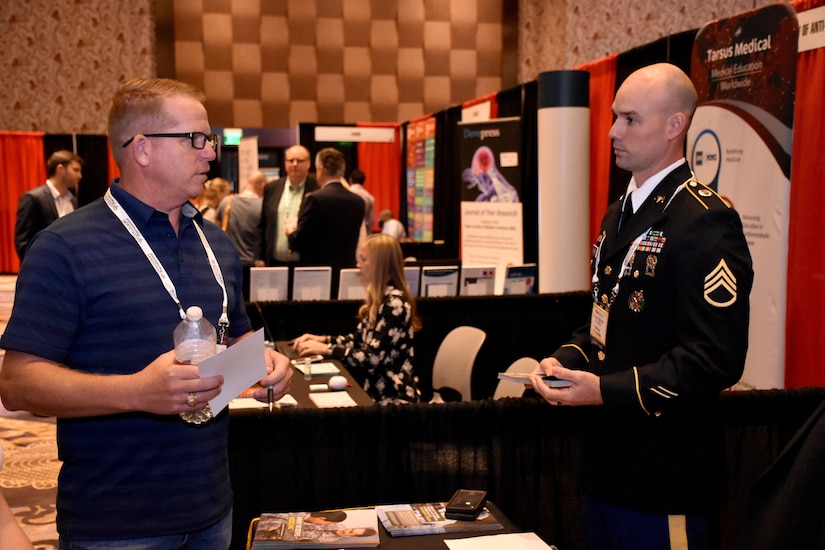 Staff Sgt. Jacob D. Varvel, U.S. Army health care recruiter, speaks with an attendee of the PAINWeek 2018 conference at The Cosmopolitan of Las Vegas. Varvel, from the Mountain Region Physician Recruiting Station, was on hand with other representatives from the Las Vegas Medical Recruiting Station and the 6th Medical Recruiting Battalion to promote the benefits and opportunities of a career in Army Medicine. For more information on the Army's more than 90 medical specialties go to healthcare.goarmy.com. (U.S. Army Photo by Andrew Lynch)
