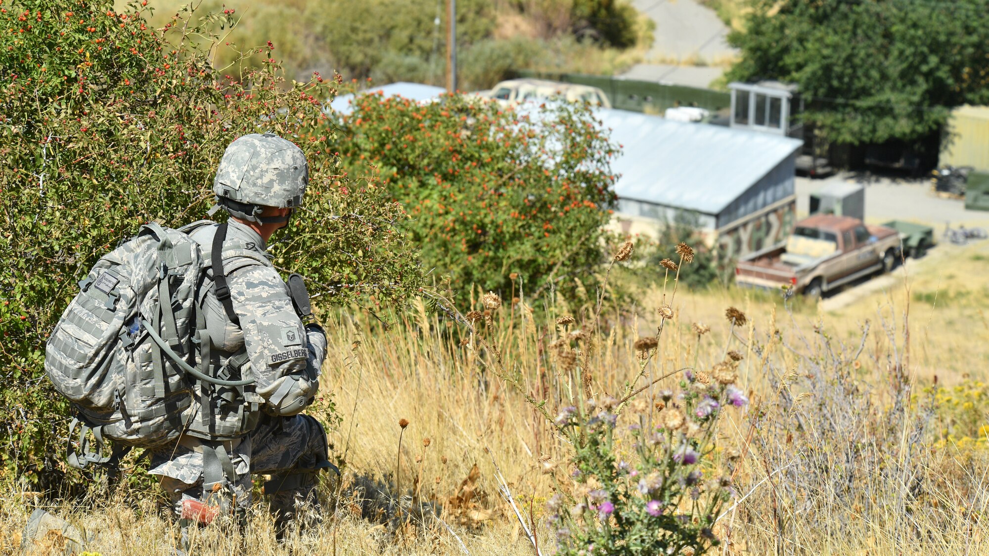 Master Sgt. Leif Gisselberg, a security forces defender from the Air Force Research Lab, Det. 15, Hawaii, overlooks a mock village during a training patrol Sept. 7, 2018, at Hill Air Force Base, Utah. Gisselberg was one of six Airmen selected to the security forces team representing Air Force Material Command at the 2018 Defender Challenge Sept. 10-14 at Camp Bullis Military Training Reservation, near San Antonio, Texas. The team will compete against 13 other teams from other U.S. Air Force major commands, Great Britain and Germany in the first 2018 Defender Challenge since 2004. (U.S. Air Force photo by R. Nial Bradshaw)