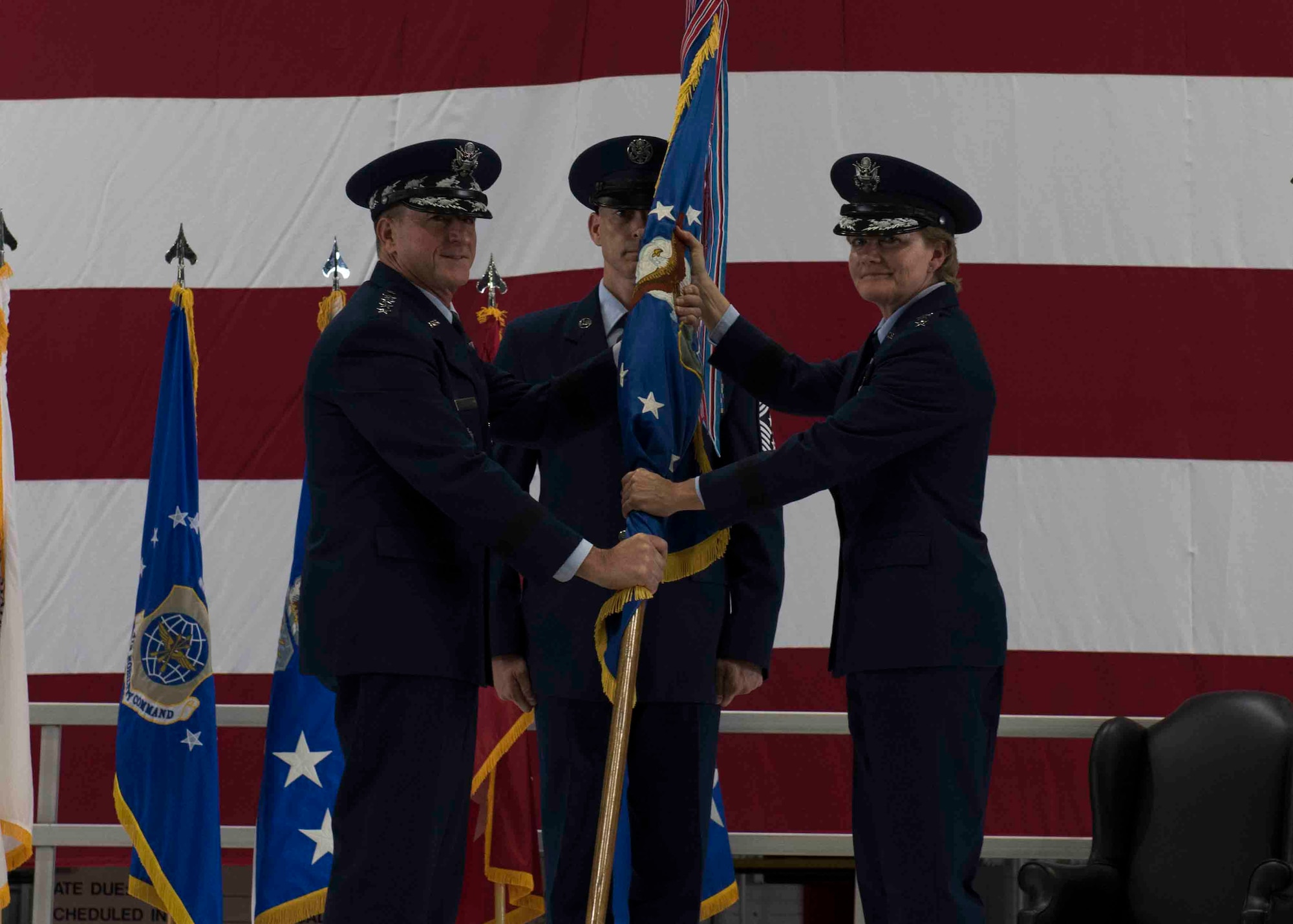 Air Force Chief of Staff Gen. David L. Goldfein passes the Air Mobility Command guidon to Gen. Maryanne Miller, who assumed command of AMC, Scott Air Force Base, Illinois, Sept. 7, 2018. Miller assumed command from Gen. Carlton D. Everhart II, who retires after 35 years of service to the Air Force. AMC provides rapid, global mobility and sustainment for America's armed forces through airlift, aerial refueling, aeromedical evacuation and mobility support. (U.S. Air Force photo by Tech. Sgt. Jodi Martinez)
