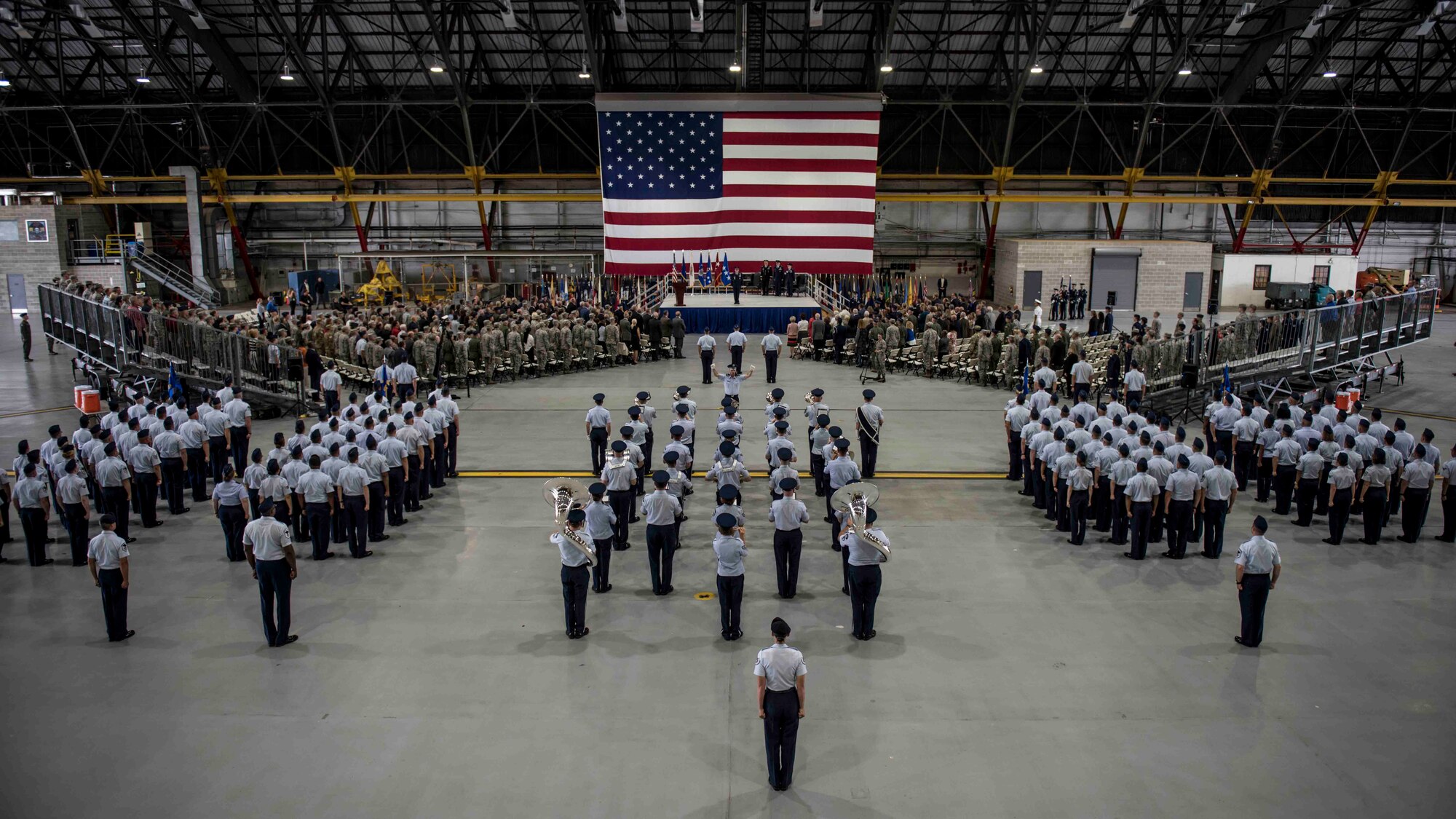 Air Force Chief of Staff Gen. David L. Goldfein stands at the front of the stage, preparing to dismiss hundreds of attendees during the Air Mobility Command change of command, where Gen. Maryanne Miller assumed command of AMC, Scott Air Force Base, Illinois, Sept. 7, 2018. Miller assumed command from Gen. Carlton D. Everhart II, who retires after 35 years of service to the Air Force. AMC provides rapid global air mobility and sustainment for America's armed forces through airlift, aerial refueling, aeromedical evacuation and mobility support.  (U.S. Air Force photo by Tech. Sgt. Jodi Martinez)