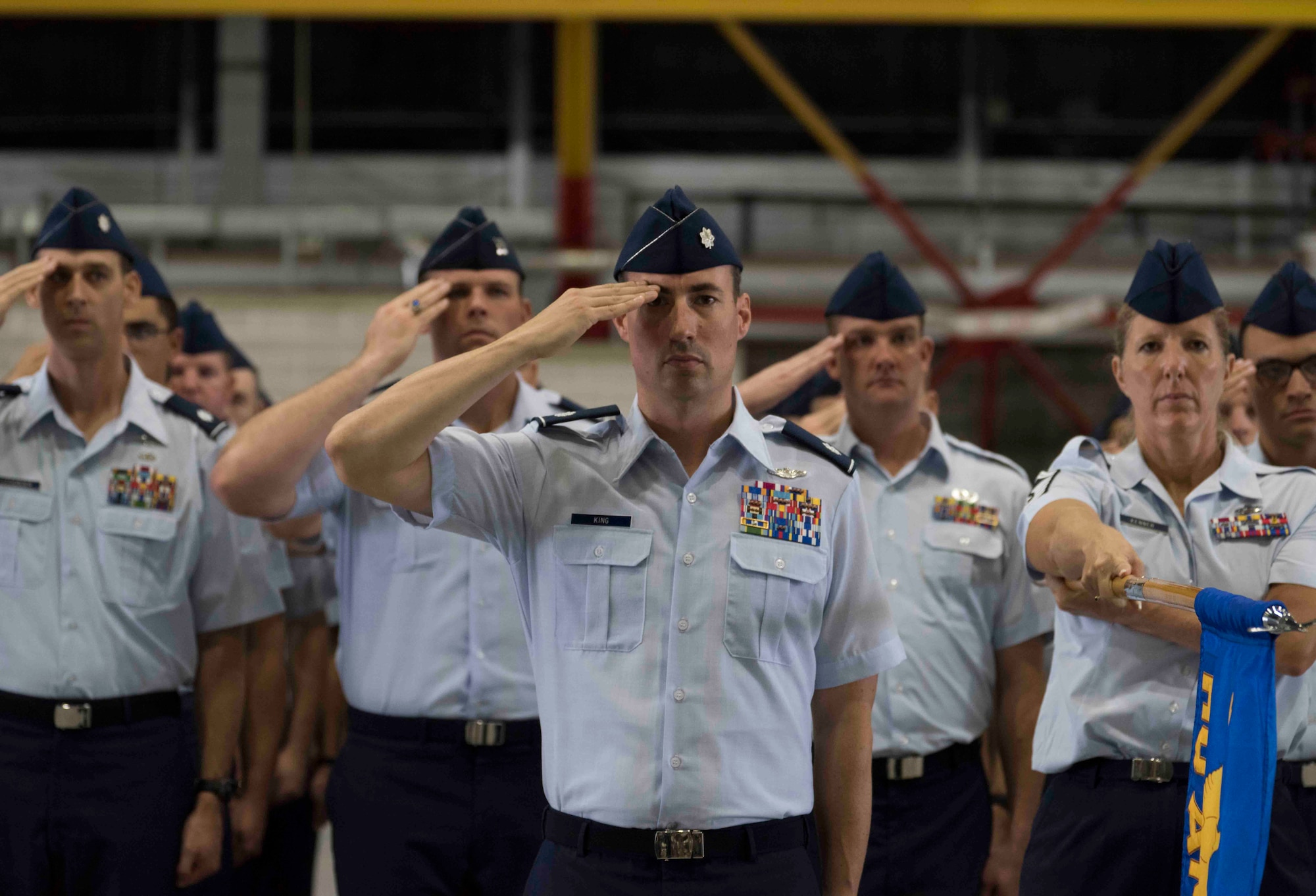 Members of a formation salute as the national anthem plays during Air Mobility Command change of command, Scott Air Force Base, Illinois, Sept. 7, 2018. Gen. Maryanne Miller assumed command from Everhart, who retires after 35 years of service to the Air Force. AMC provides rapid, global mobility and sustainment for America's armed forces through airlift, aerial refueling, aeromedical evacuation and mobility support. (U.S. Air Force photo by Tech. Sgt. Jodi Martinez)