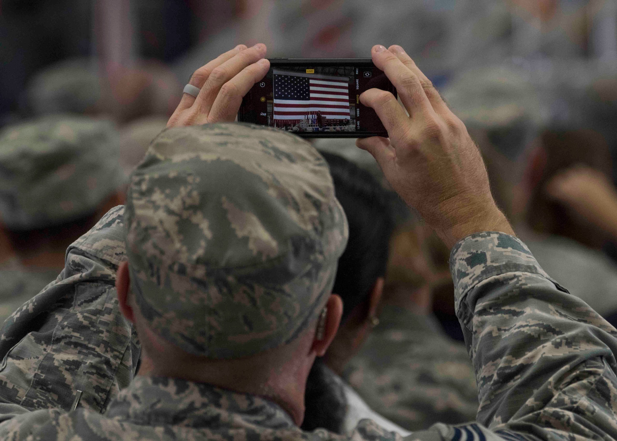 An attendee takes a photo of Gen. Carlton D. Everhart II, Air Mobility Command commander, as he gives his final speech as the AMC commander during the AMC change of command ceremony, Scott Air Force Base, Illinois, Sept. 7, 2018. Gen. Maryanne Miller assumed command from Gen. Carlton D. Everhart II, who retires after 35 years of service to the Air Force. AMC provides rapid global air mobility and sustainment for America's armed forces through airlift, aerial refueling, aeromedical evacuation and mobility support. (U.S. Air Force photo by Tech. Sgt. Jodi Martinez)