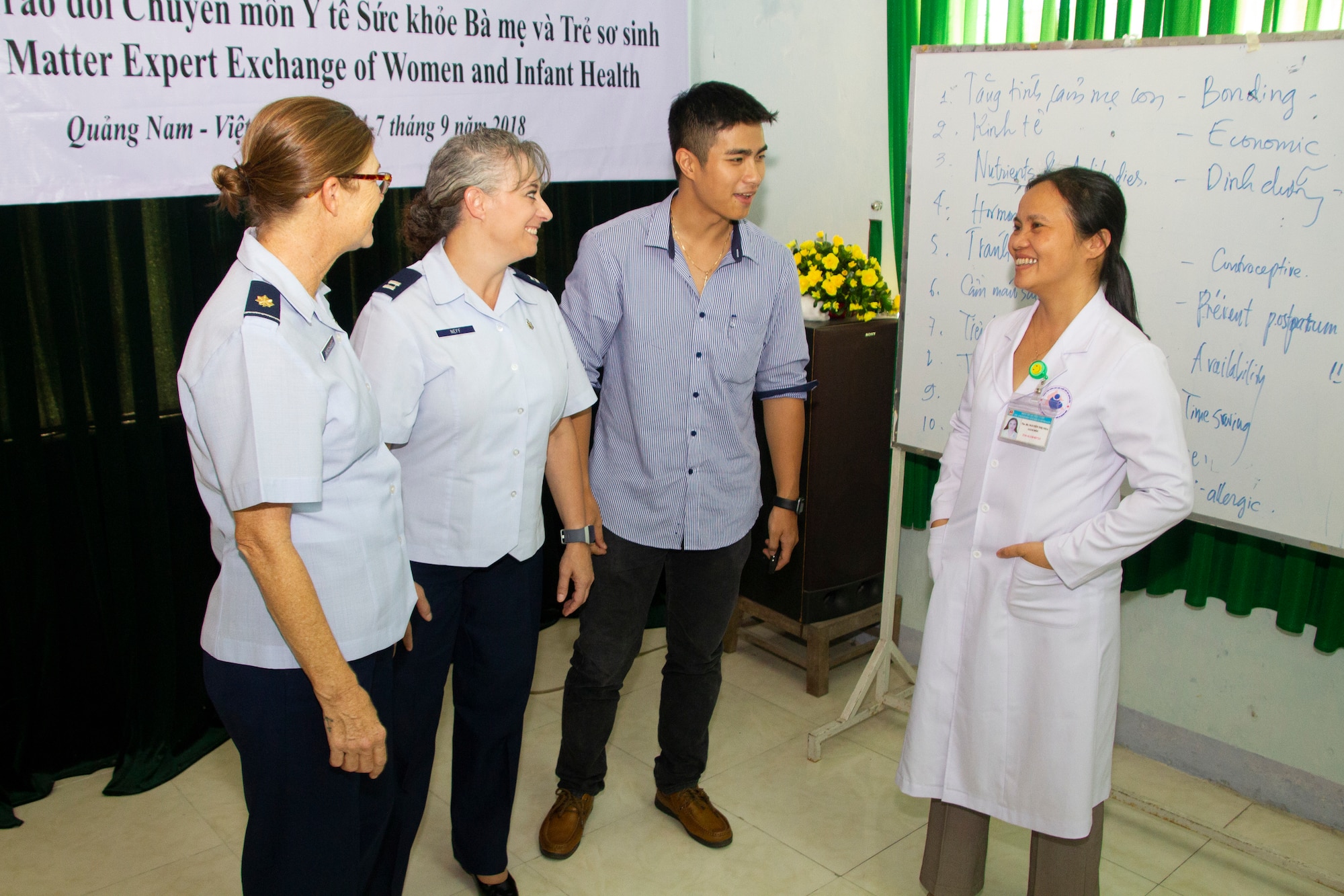 (From left to right) U.S. Air Force Maj. Tamera Borchardt,  doctor of nursing practice, Hurlburt Field, Florida, and U.S. Air Force Capt. Tammy Neff,  registered nurse certified inpatient obstetrics, Joint Base Elmendorf-Richardson, Alaska, with An Duy Ho, an interpreter, discuss women and infant health issues with Dr. Nha Thi Nguyen, director of Quang Nam Department of Health, Reproductive Health Care Center, during a Pacific Angel (PAC ANGEL) 18-2 subject matter expert exchange in Tam Ky, Quang Nam province, Vietnam, Sept. 6, 2018.