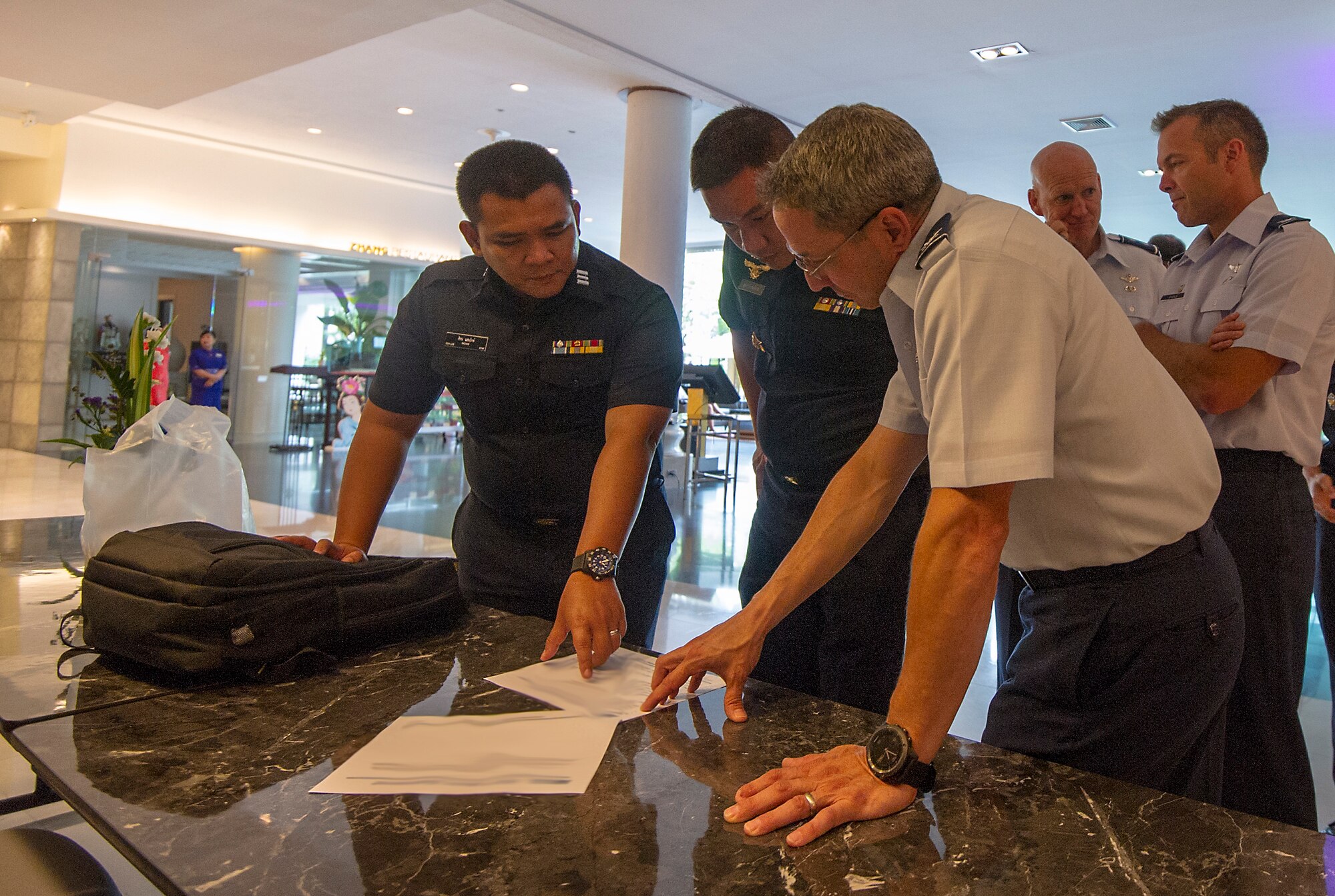 (Right) U.S. Air Force Col. Francis Scolaro, 194th Wing Air Support Operations Group commander, discusses training and tactics with (left) Royal Thai Air Force (RTAF) Gp. Capt. Watchara Sakunrat, RTAF Security Forces deputy director of Operation Division, and (middle) RTAF Sqdrn. Ldr. Sichon, Special Operations Regiment specialist, during the fifth RTAF-PACAF Airman-to-Airman (A2A) talks in Bangkok, Thailand, Aug. 21, 2018.