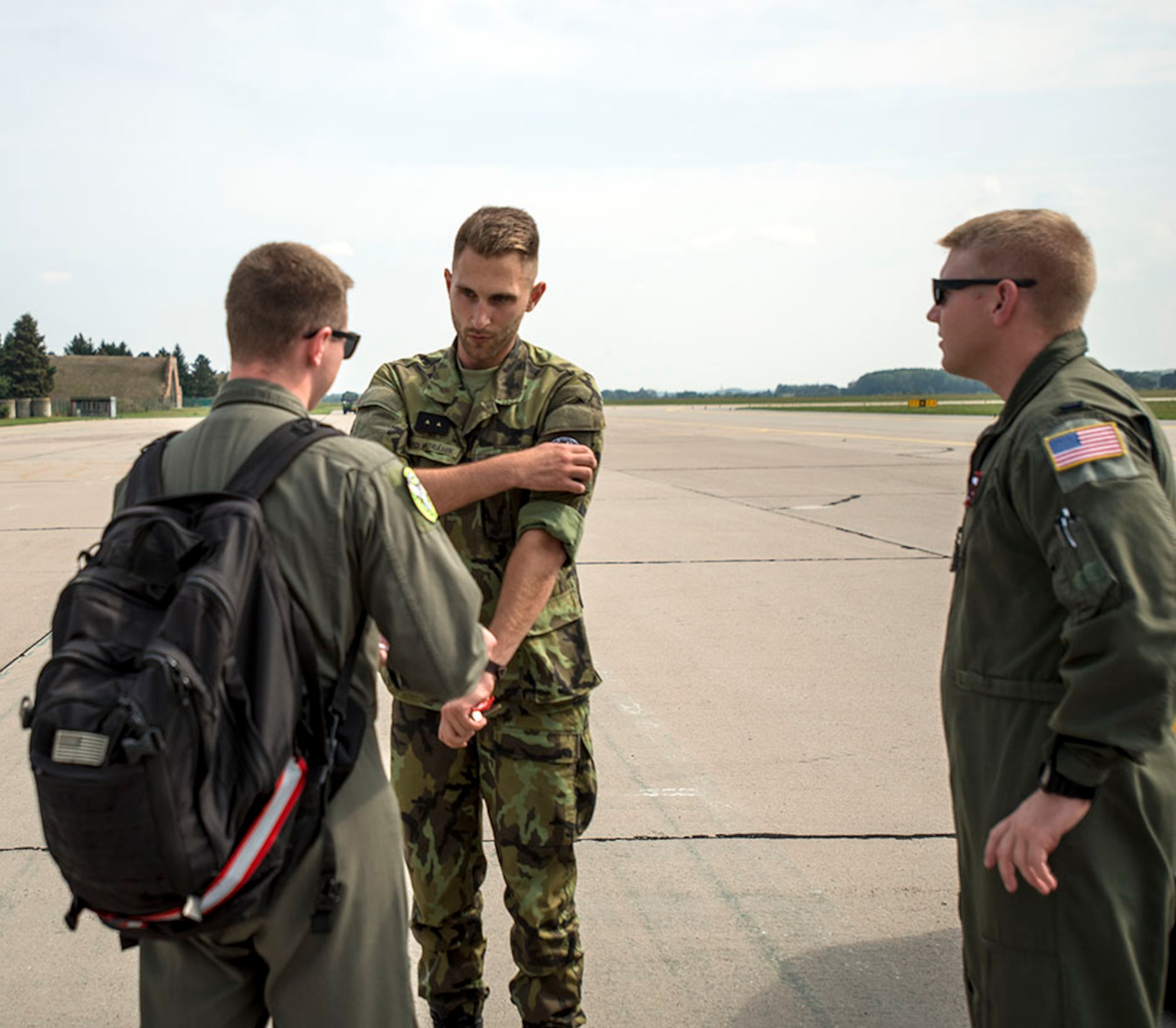Staff Sgt. Matthew Parker, in-flight refueling specialist, 155th Air Refueling Wing, Nebraska Air National Guard, exchanges patches with grounds service technician assigned to Pardubice Air Base, Czech Republic, with 1st Lt. Taylor Ashmore, 155th ARW mission pilot, after a refueling flight during a joint training exercise in the Pardubice Region. This year the State of Nebraska, and the State of Texas, are celebrating the 25th year of their partnership with the Czech Republic through the State Partnership Program (SPP). The ANG has 73 partnerships around the world to promote access, enhance military capabilities, improve interoperability, and enhance the principles of responsible governance. (U.S. Air National Guard photo by Tech. Sgt. Rana Franklin)