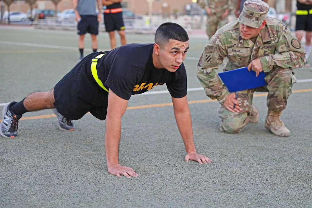 A soldier performs a pushup.