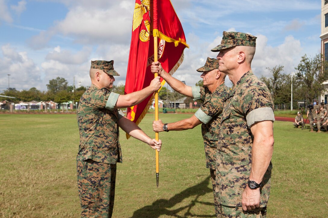 Sgt. Maj. Scott D. Grade, left, sergeant major of Marine Forces Reserve and Marine Forces North, passes the MARFORNORTH colors to Lt. Gen. Rex C. McMillian, outgoing commander of MARFORRES and MARFORNORTH, Sept. 8, 2018, at Marine Corps Support Facility New Orleans.  McMillian relinquished his duties to Maj. Gen. Burke W. Whitman. (U.S. Marine Corps photo by Lance Cpl. Tessa D. Watts)