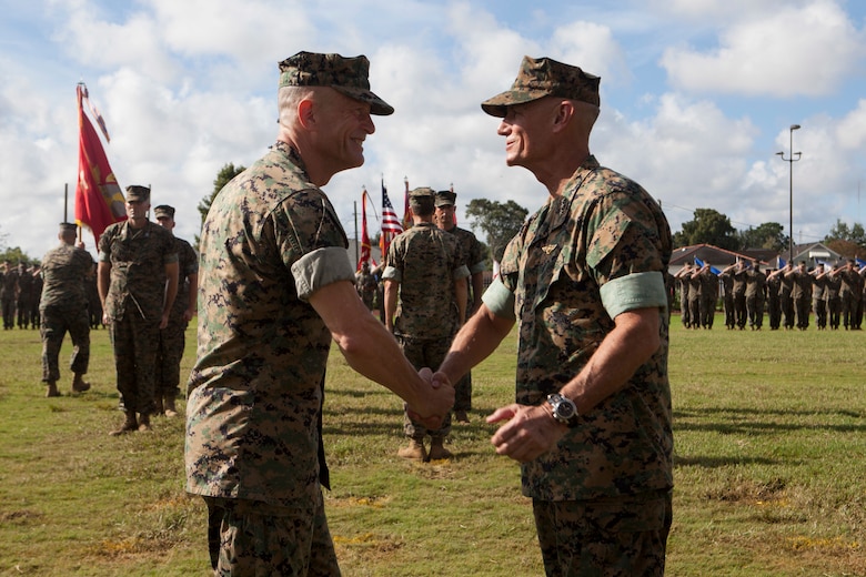 Lt. Gen. Rex C. McMillian, right, outgoing commander of Marine Forces Reserve and Marine Forces North congratulates Maj. Gen. Burke W. Whitman, incoming commander of MARFORRES and MARFORNORTH during the change of command ceremony Sept. 8, 2018, at Marine Corps Support Facility New Orleans. McMillian served as the commander from 2015-2018. (U.S. Marine Corps photo by Lance Cpl. Tessa D. Watts