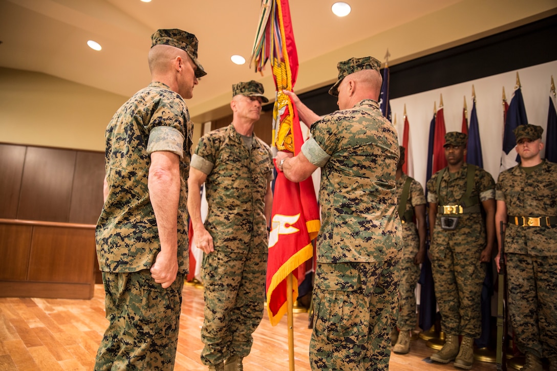 Brig. Gen. Michael S. Martin, right, incoming commanding general of 4th Marine Division, takes the unit colors from Maj. Gen. Burke W. Whitman, outgoing commander of 4th MarDiv, during a change of command ceremony held at Marine Corps Support Facility New Orleans, Sept. 8, 2018. Whitman served as the commanding general of 4th MarDiv from 2017-2018 and will now serve as the commander of Marine Forces Reserve and Marine Forces North. (U.S. Marine Corps photo by Sgt. Melissa Martens)