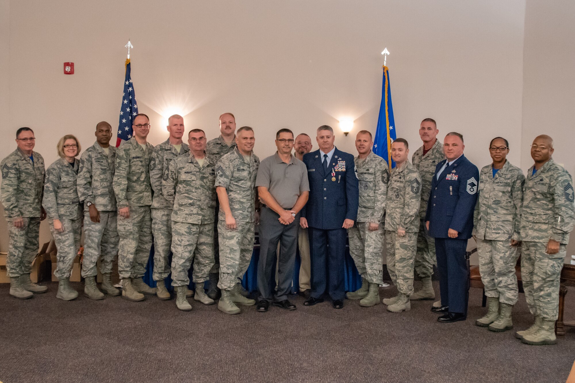Retired Chief Master Sgt. Steven Vogle poses for a photo with other Chiefs he worked with throughout his career following his retirement ceremony at Barksdale Air Force Base, Sept. 8, 2018. Vogle served more than 34 years in the U.S. Air Force before his retirement. (U.S. Air Force photo by Tech. Sgt. Cody Burt/Released)