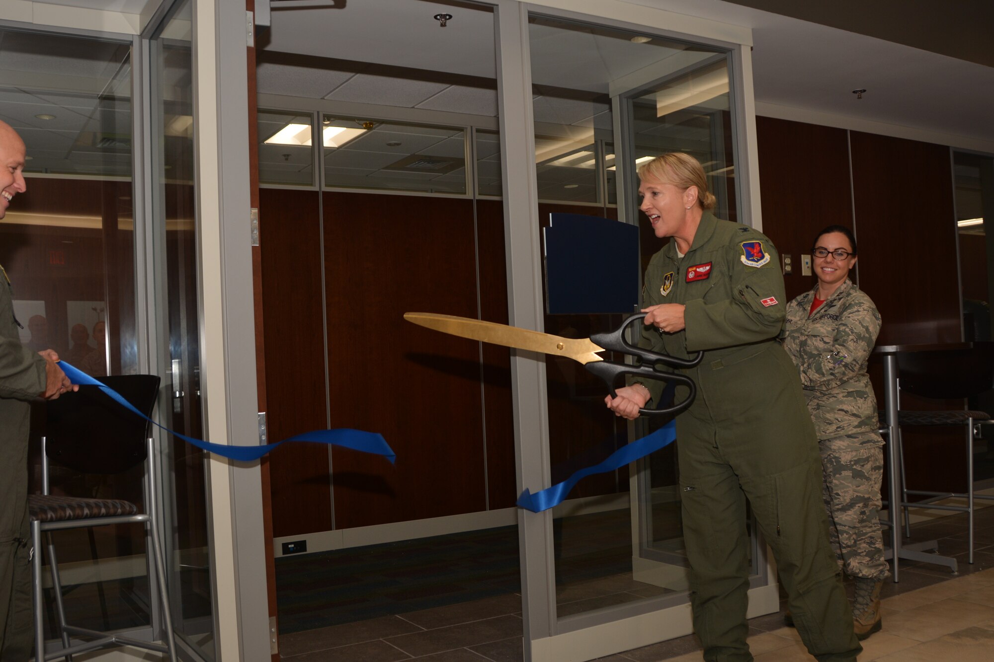 With a quick motion of oversized scissors, Col. Laurie Dickson, Commander, 513th Air Control Group, officially "opens" the new 513th ACG headquarters for business Sept. 7, 2018, at Tinker Air Force Base, Oklahoma. The 513th Air Control Group is the only Air Force Reserve unit to fly and maintain the E-3 Sentry, an Airborne Warning and Control System aircraft that provides surveillance, warning and tactical control of U.S. and allied military aircraft.  As a Reserve associate unit, Airmen assigned to the 513th ACG work hand-in-hand with the active-duty 552nd Air Control Wing, which is responsible for the E-3 Sentry aircraft assigned to Tinker AFB. Working together, Tinker AFB's Team AWACS maintains a reliable presence in numerous missions worldwide. (Air Force photo by Master Sgt. Grady Epperly)