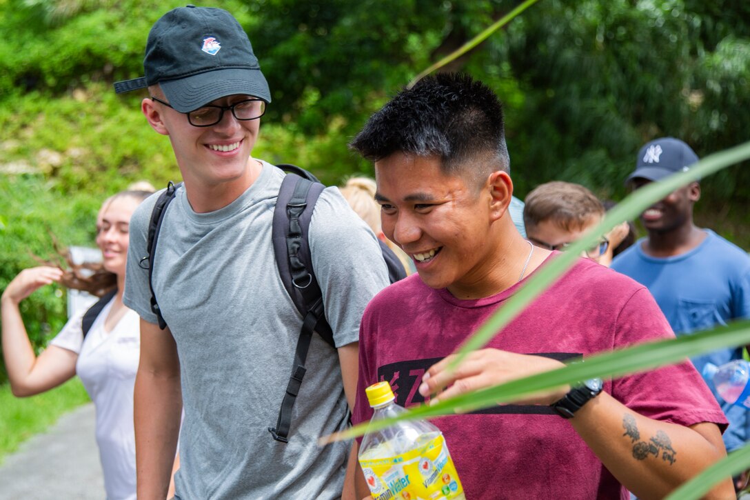 Lance Cpl. Tulio Barbosa, left, and Lance Cpl. Lester M. Muldong take part in a tour Sept. 7, 2018 at Hacksaw Ridge, Okinawa, Japan. Marines and Sailors with Headquarters Company, Headquarters Regiment, 3rd Marine Logistics Group, participated in the World War II battle site tour to learn about the U.S. Marine Corps’ history on Okinawa and remember those who have gone before them. Barbosa is a motor transportation mechanic with Motor Transportation Platoon, HQ Co., HQ Reg. and is a native of Bridgewater, Massachusetts. Muldong is a motor transportation operator with Motor Transportation Plt., HQ Co., HQ Reg. and is a native of Valdosta, Georgia. (U.S. Marine Corps photo by Pfc. Terry Wong)