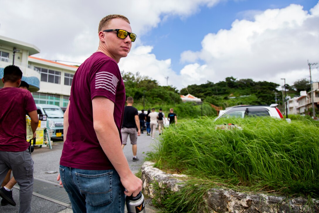 Cpl. Mackinley E. Dyess peers back at his fellow Marines during a tour Sept. 7, 2018 at Hacksaw Ridge, Okinawa, Japan. Marines and Sailors with Headquarters Company, Headquarters Regiment, 3rd Marine Logistics Group, participated in the World War II battle site tour to learn about the U.S. Marine Corps’ history on Okinawa and remember those who have gone before them. Dyess is a radio technician with Jump Platoon, HQ Co., HQ Reg. and is a native of Fort Worth, Texas. (U.S. Marine Corps photo by Pfc. Wong)