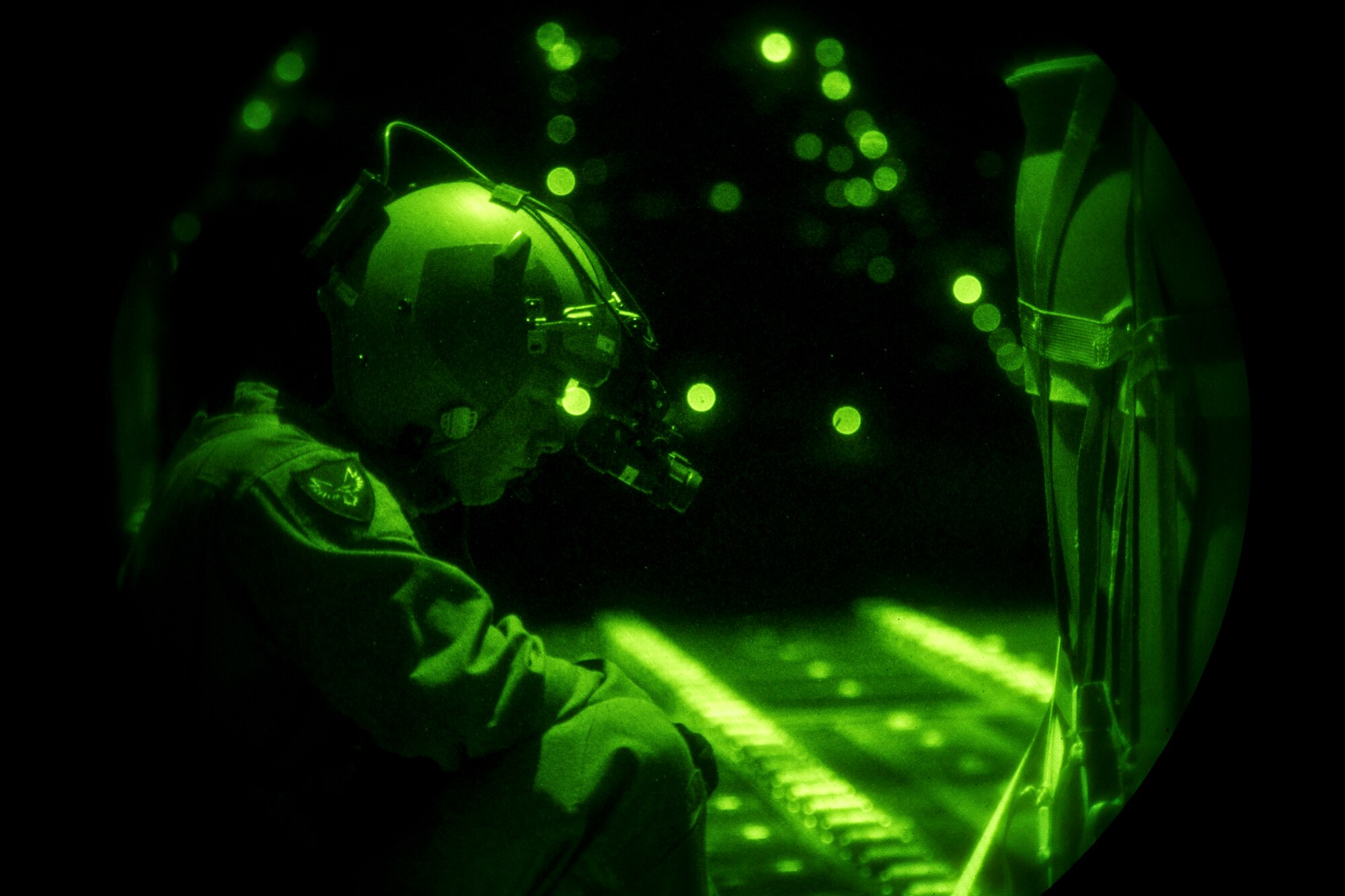 A U.S. Air Force loadmaster assigned to the 37th Airlift Squadron prepares to cut the restraints of a container delivery system to airdrop it from a C-130J Super Hercules over Romania, Aug. 28, 2018. The night operation was part of Carpathian Summer 2018, a bilateral training exercise designed to enhance interoperability and readiness of forces by conducting combined air operations with the Romanian air force. (U.S. Air Force photo by Senior Airman Devin Boyer)