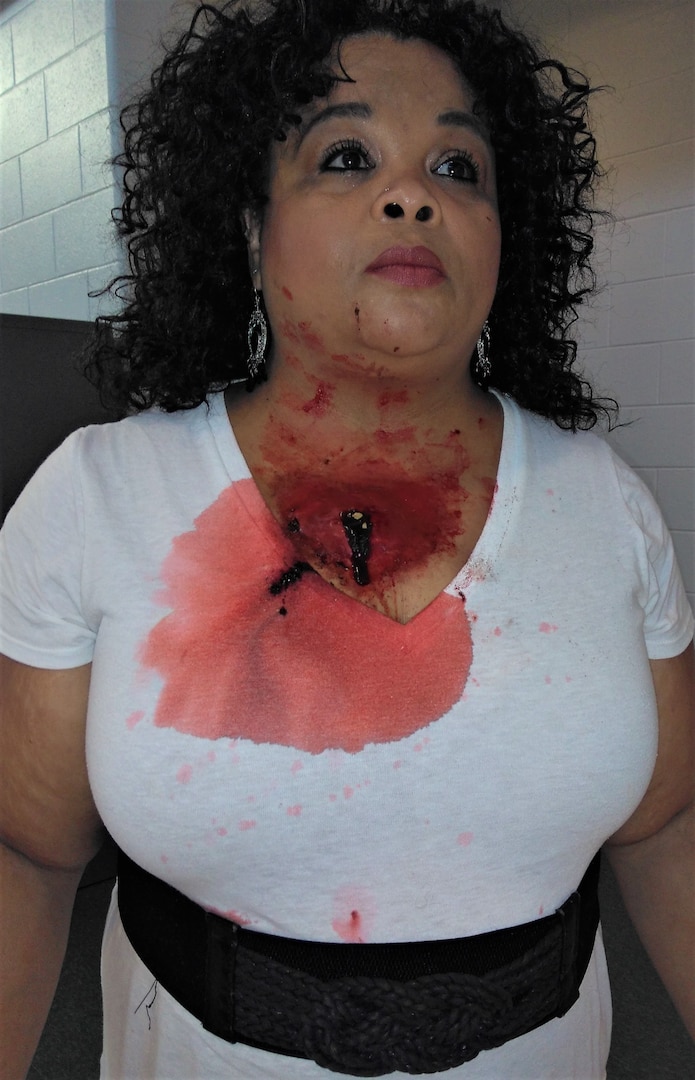 Woman standing, displaying faux neck wound