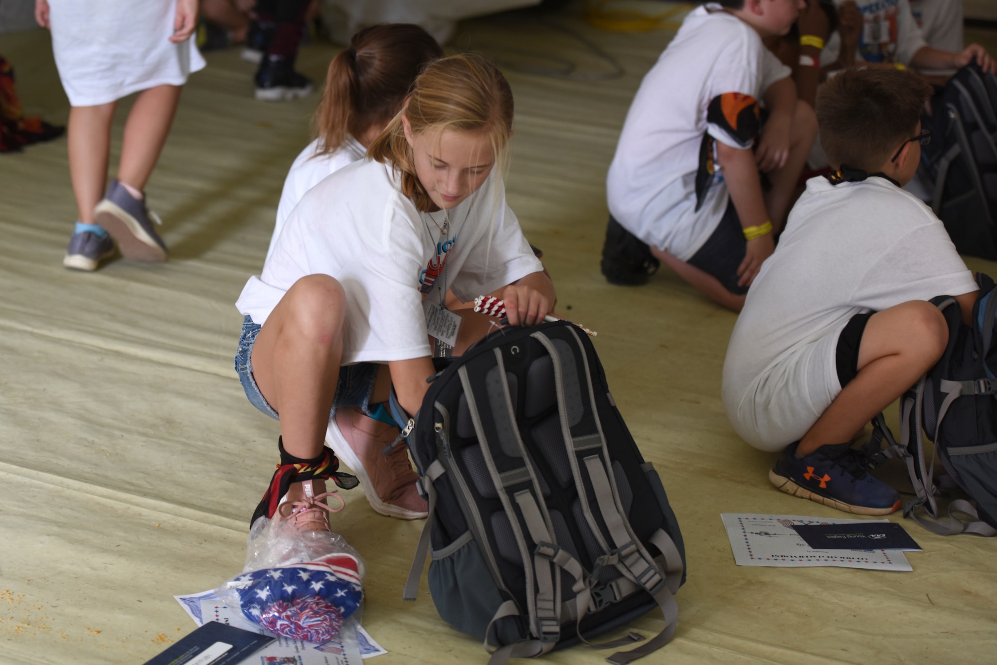 Children of North Carolina (NC) Air National Guardsmen were given backpacks filled with military memorabilia and donated gifts following the Annual NC Operation Kids on Guard held at the NC Regional Training Site in Stanly County, Sept. 8, 2018. Children of military members were able to join in activities including short aircraft rides, engaging with military members while learning flight structure and commands, interactive displays with a C-17 Globemaster III and other aircraft, as well as a ropes course and bouncy castles.