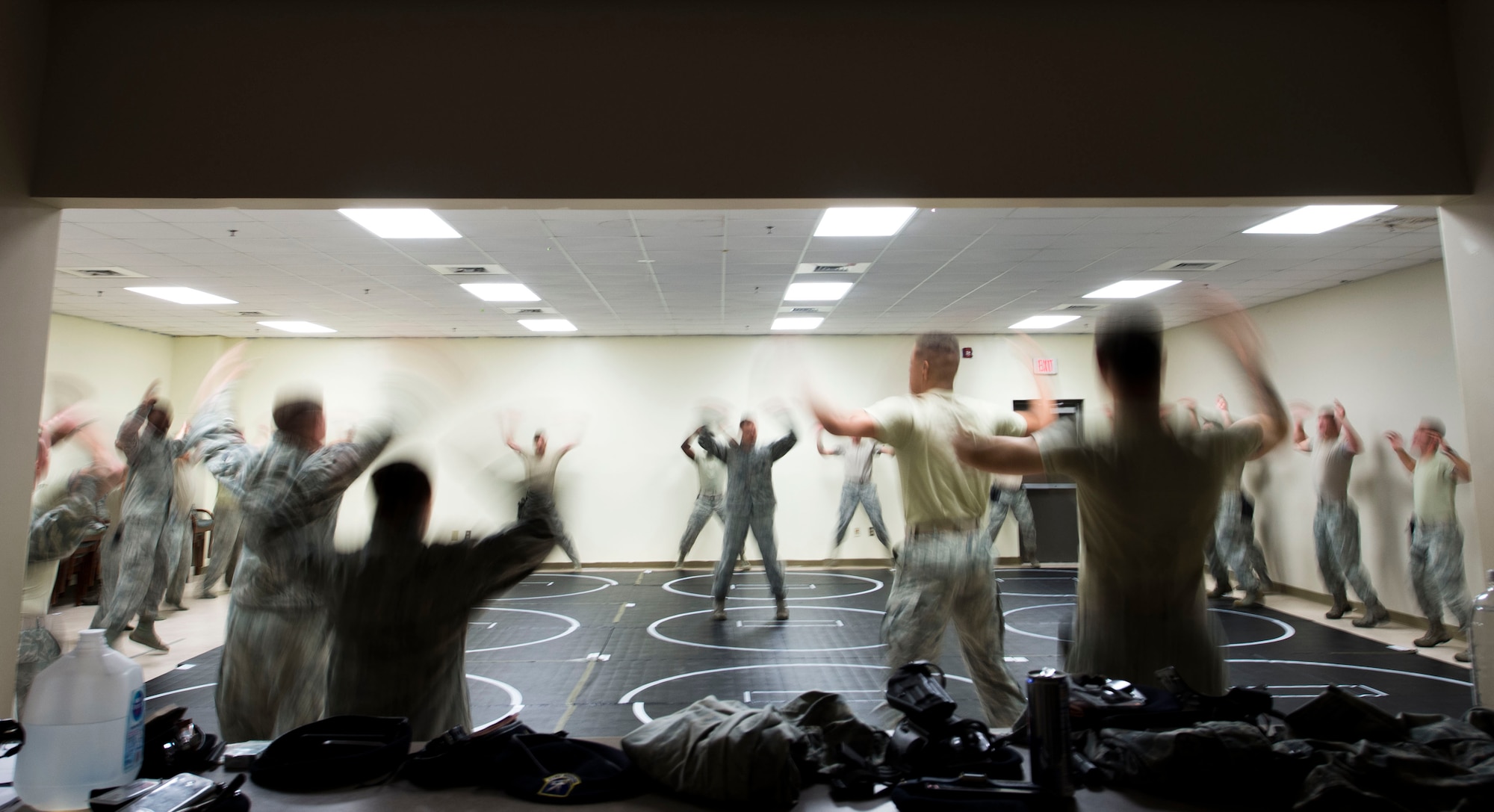 U.S. Airmen assigned to the 20th Security Forces Squadron perform jumping-jacks prior to beginning combatives training at Shaw Air Force Base, S.C., Sept. 5, 2018.