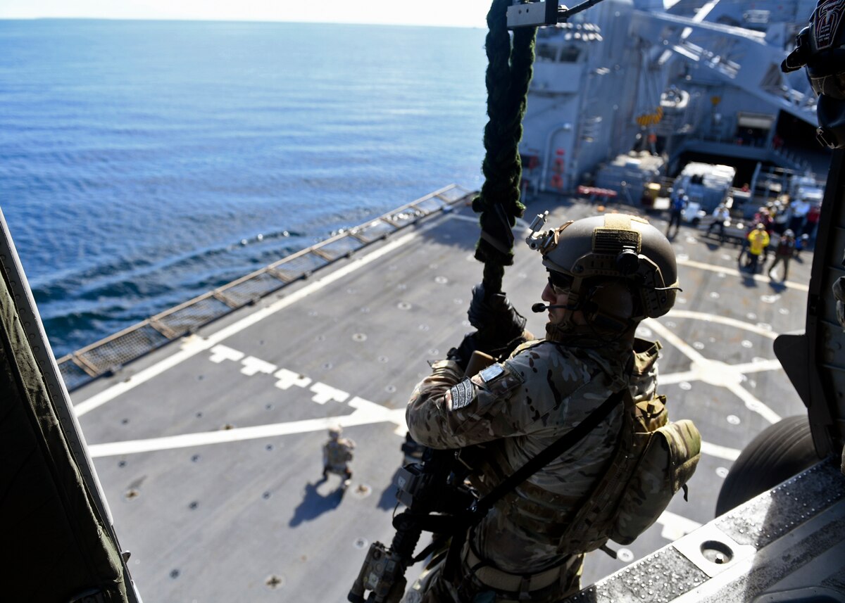 U.S. and Colombian forces conduct fast rope exercises from an Army UH-60L helicopter aboard USS Gunston Hall.