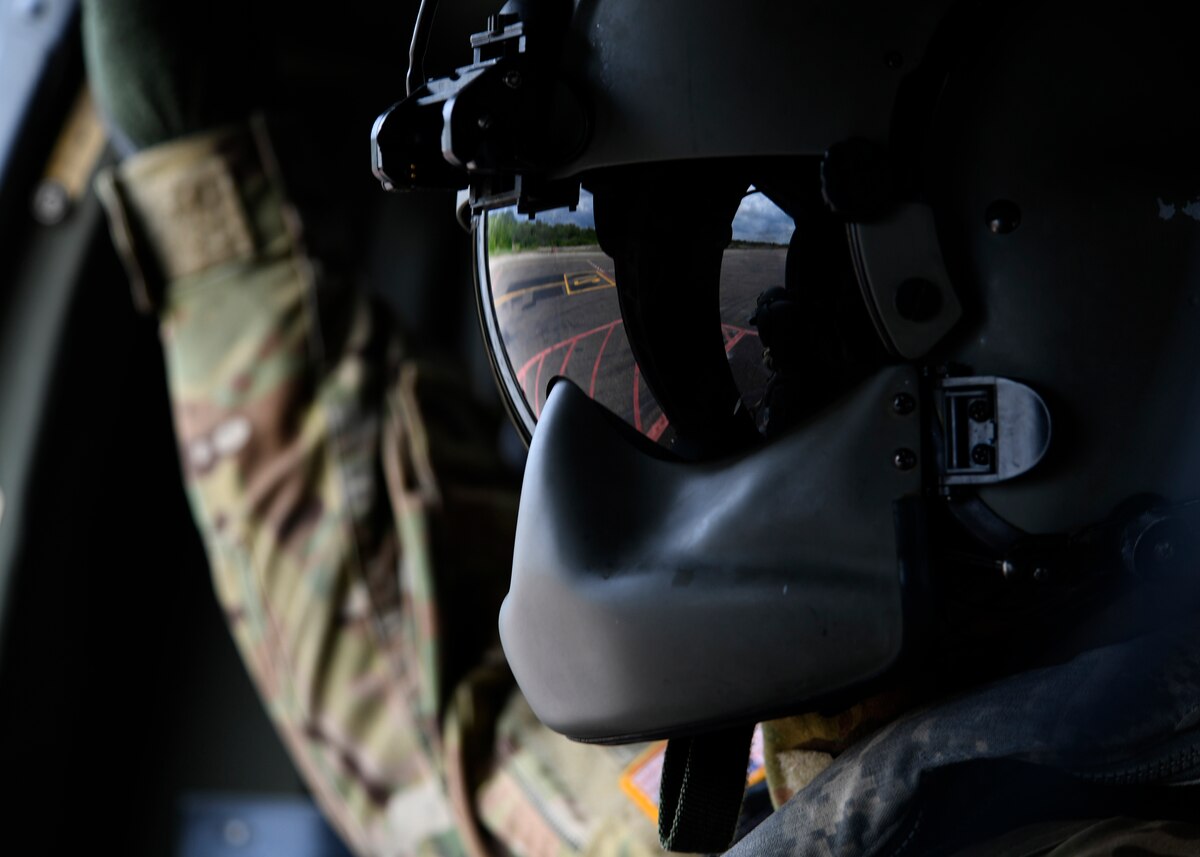 A U.S. Soldier observes the flight line from an Army UH-60L helicopter prior to takeoff.