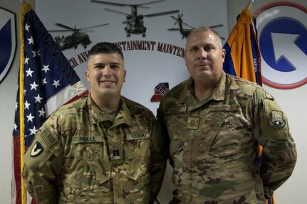 U.S. Air Force Chief Master Sgt. Andre Paille, a project manager with the 214th Engineering Installation Squadron, Louisiana Air National Guard, attached to U.S. Air Force Central, and his son, U.S. Army Capt. Joshua Paille, commander of Headquarters and Headquarters Detachment 1109th Theater Aviation Sustainment Maintenance Group, attached to Task Force 22, had an opportunity to spend a day together at the airfield where Joshua Paille works at Camp Arifjan, Kuwait, Sept. 1, 2018.