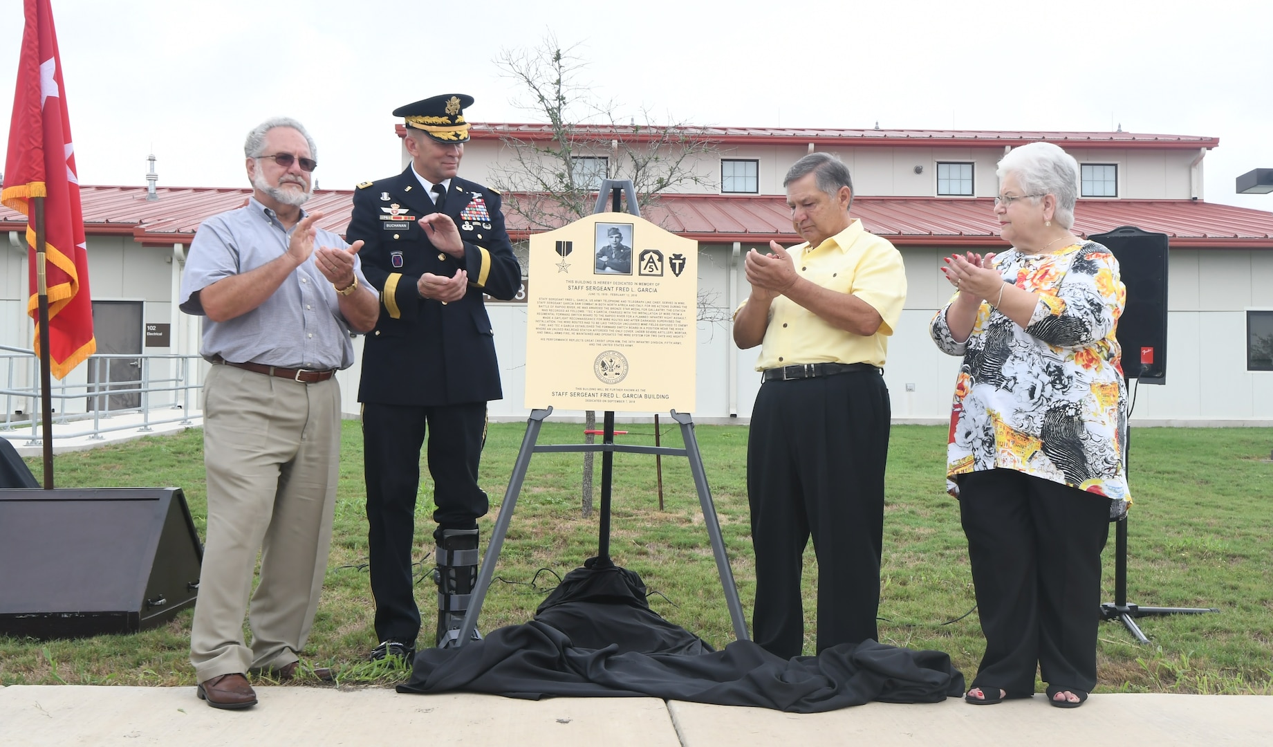 Staff Sgt. Fred Garcia, a U.S. Army telephone and telegraph line chief who fought in World War II and was awarded the Bronze Star for his actions during the Battle of Rapido River in Italy, was honored during a building memorialization ceremony at Joint Base San Antonio-Fort Sam Houston Sept. 7. Garcia was a San Antonio native and a direct descendent of the Padron family, one of the original 16 families who founded the city. Lt. Gen. Jeffrey Buchanan (center, left), commanding general, U.S. Army North, joins (from right) Kenneth Garcia, Wayne Garcia and Diana Garcia-Schulze, all children of the late Staff Sgt. Fred Garcia, in the unveiling of the commemorative plaque to be mounted at the entrance of the U.S. Army North (5th Army)  communications building, the Staff Sgt. Fred L. Garcia building.