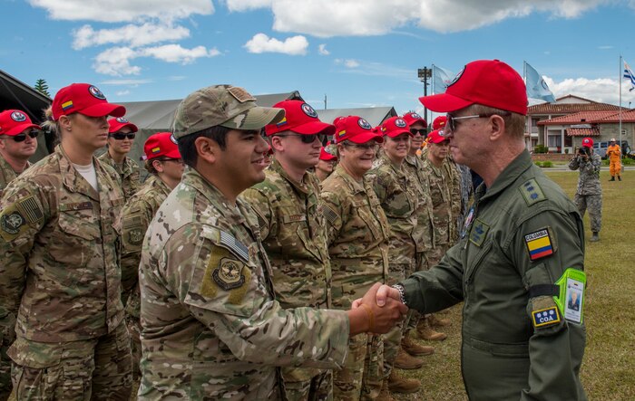U.S. Air Force Staff Sgt. Joseph Eli Elizondo, 571st Mobility Support Advisory Squadron force protection team sergeant, greets Colombian Air Force Chief of Staff Gen. Carlos Eduardo Bueno Vargas, during the opening ceremony of exercise Angel de los Andes, Sept. 3, 2018, at Air Combat Command-5, Rionegro, Colombia.