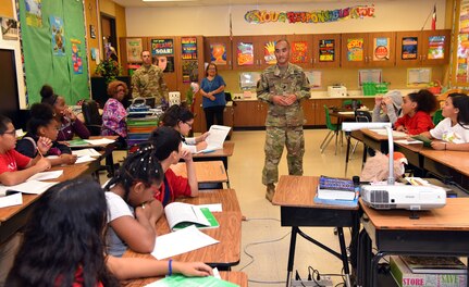 Command Sgt. Major Lee Yoneyama of the 470th Military Intelligence Brigade at Joint Base Base San Antonio-Fort San Houston speaks to a science class of eighth grade students at Bowden Academy.
