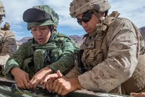 U.S. Marine Corps Cpl. Miguel Orellana, a combat engineer with 1st Combat Engineer Battalion, teaches a class on an Expedient Bangalore to Soldiers from Singapore Armed Forces during exercise Valiant Mark 2018 at Marine Corps Air-Ground Combat Center Twentynine Palms, Calif. Aug. 28, 2018.