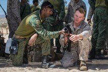 A Soldier from the Singapore Armed Forces shows U.S. Marine Corps LCpl. Dom Depuglia a Singapore Assault Rifle 21st Century during exercise Valiant Mark 2018 at Marine Corps Air-Ground Combat Center Twentynine Palms, Calif. Aug. 30, 2018