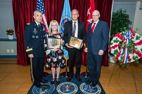 The Cavanaugh and Mitchell families receive a memento honoring Sgt. Townsend from General Paul M. Nakasone, Director  National Security Agency, and George C. Barnes, Deputy Director  National Security Agency.