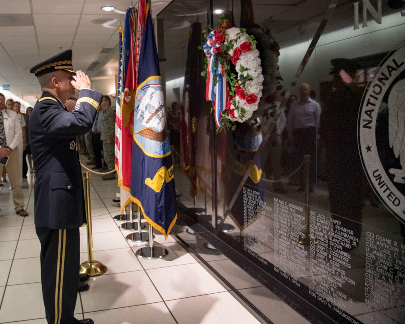 General Paul M. Nakasone  Director  National Security Agency  salutes the Memorial Wall.