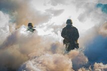 U.S. Marines run through CS gas during the hike portion of the 1st Marine Division (MARDIV) Super Squad Competition at Marine Corps Base Camp Pendleton, California, Aug. 30, 2018.