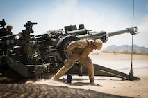 U.S. Marine Corps Cpl. Elijah Feliciano, an assistant gunner with 2nd Battalion, 11th Marines, 1st Marine division (MARDIV), pulls the firing cord on an M777 towed 155mm howitzer during exercise Summer Fury, at Range 2057 South, Calif., Aug. 1, 2018.