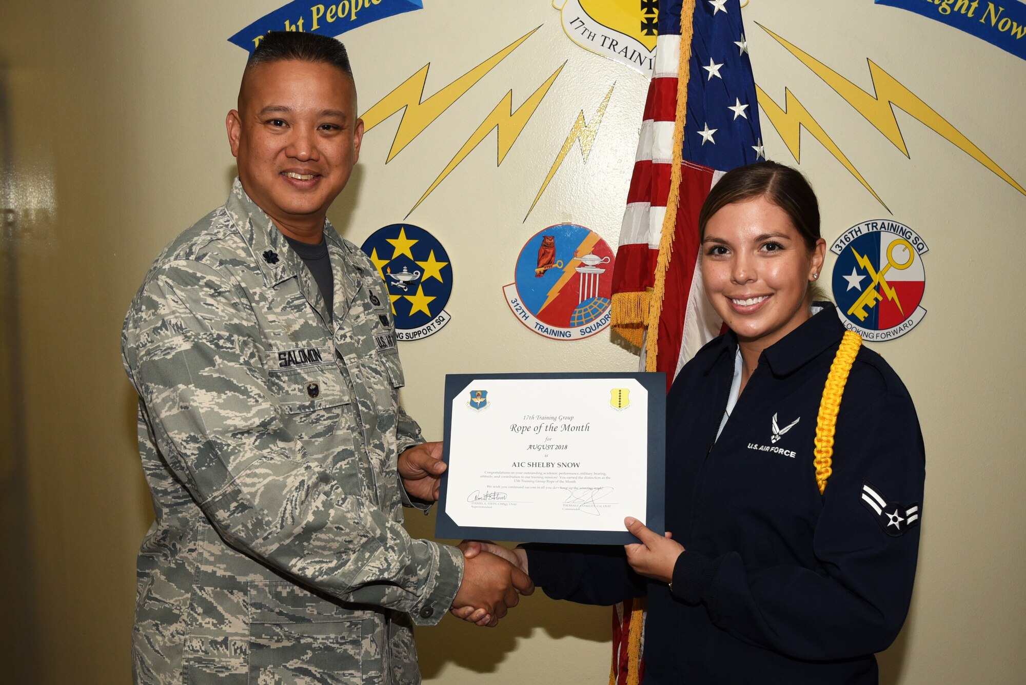 U.S. Air Force Lt. Col. Abraham Salomon, 17th Training Group deputy commander, presents the 17th TRG Rope of the Month award to Airman 1st Class Shelby Snow, 315th Training Squadron student, at Brandenburg Hall on Goodfellow Air Force Base, Texas, Sept. 7, 2018. Military Training Leaders present ropes to Airmen who display exceptional leadership qualities to lead their peers. (U.S. Air Force photo by Staff Sgt. Joshua Edwards/Released)
