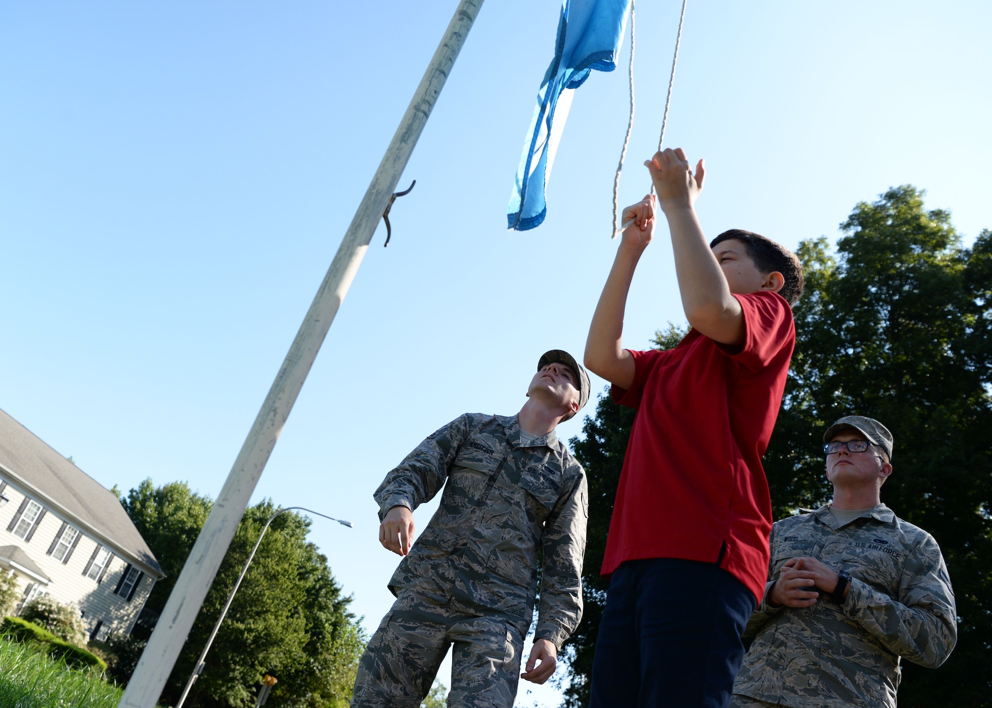 Richard Roman, seventh grade student, raises the flag Sept. 5, 2018, at St. John’s Lutheran School. St. John’s seventh and eighth graders took turns raising and lowering the flag to ensure they knew the proper procedures. (U.S. Air Force photo by Airman 1st Class Zoe M. Wockenfuss)