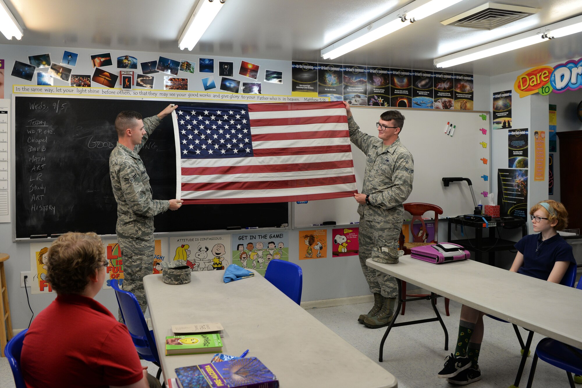 Airmen 1st Class Mason Kreitzer and Kyle Wood, members of Dover Air Force Base’s Honor Guard, demonstrate how to properly fold the American Flag to seventh and eighth grade students Sept. 5, 2018, at St. John’s Lutheran School. Kreitzer and Wood taught the students the correct way to fold, raise, lower and carry the American flag. (U.S. Air Force photo by Airman 1st Class Zoe M. Wockenfuss)