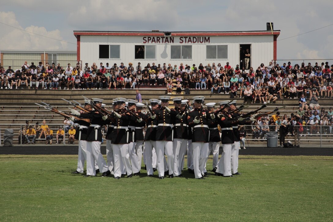 The Silent Drill Platoon performs for students at Sun Valley High School in Monroe, North Carolina, during the United States Marine Corps’ 2018 Marine Week in Charlotte, North Carolina, Sept. 4, 2018. Marine Week is a celebration of community, country and Corps, which provided the American public the experience of directly connecting with approximately 750 Marines. The Marine Corps Recruiting Command planned unique engagements during Marine Week to interact with important components of the Charlotte population, looking to share its message of opportunity with a diverse audience of people who in many cases had little previous exposure to our culture. The Silent Drill Platoon is stationed at Marine Barracks Washington in the District of Columbia. (Marine Corps photo by Lance Cpl. Naomi Marcom)