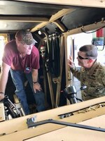 RED RIVER ARMY DEPOT, Texarkana, Texas – Maj. Gen. Flem B. “Donnie” Walker, Jr., commanding general, 1st Theater Sustainment Command, right, speaks with a Red River Army Depot facility employee inside an Army Heavy Equipment Transport vehicle, Aug. 23. Walker toured the facility, learning about the rebuilding of Army Heavy Equipment Transports. (U.S. Army photo by Cpt. Van Hauter)