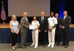 Group photo of military and civilian personnel receiving an award