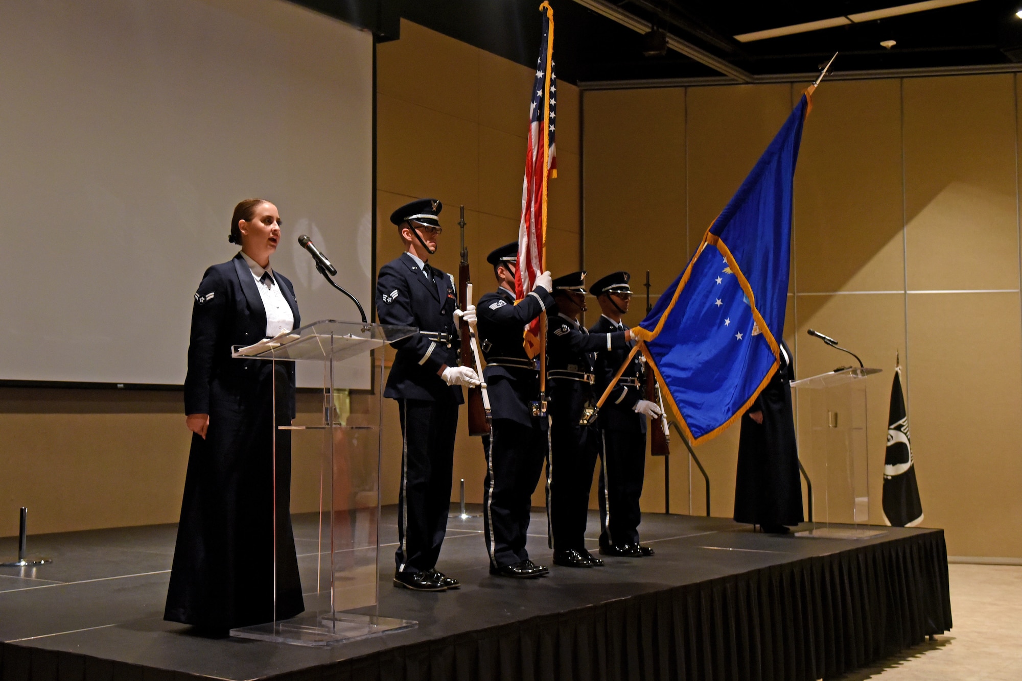 U.S. Air Force Band of the West sings “The Star-Spangled Banner” while the honor guard present arms during the Air Force Ball at the McNease Convention Center in San Angelo, Texas, Sept. 8. 2018.  This year’s Air Force Ball was themed ‘lest we forget,’ focusing on the 100 year anniversary of World War I and the heritage of Lt. John Goodfellow and Goodfellow Air Force Base. (U.S. Air Force photo my Airman 1st Class Zachary Chapman/Released)