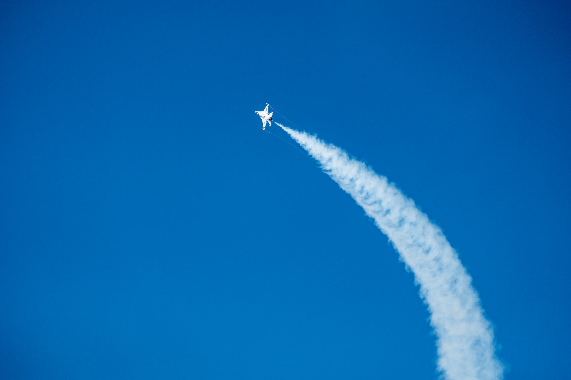 A member of the U.S. Thunderbirds performs for Team McConnell at the Frontiers in Flight Open House and Airshow Sept. 9, 2018, McConnell Air Force Base, Kan. In 1953 the Air Force activated the 3600th Demonstration Unit, which adopted the name “Thunderbirds,” establishing a 55-year heritage of displaying the capabilities of the most powerful Air Force in the world. (U.S. Air Force Photo by Staff Sgt. Preston Webb)